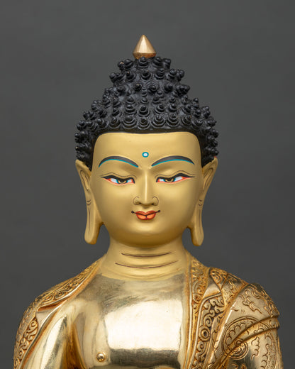 Close-up Buddha hands in earth-touching mudra holding begging bowl with gold-painted face