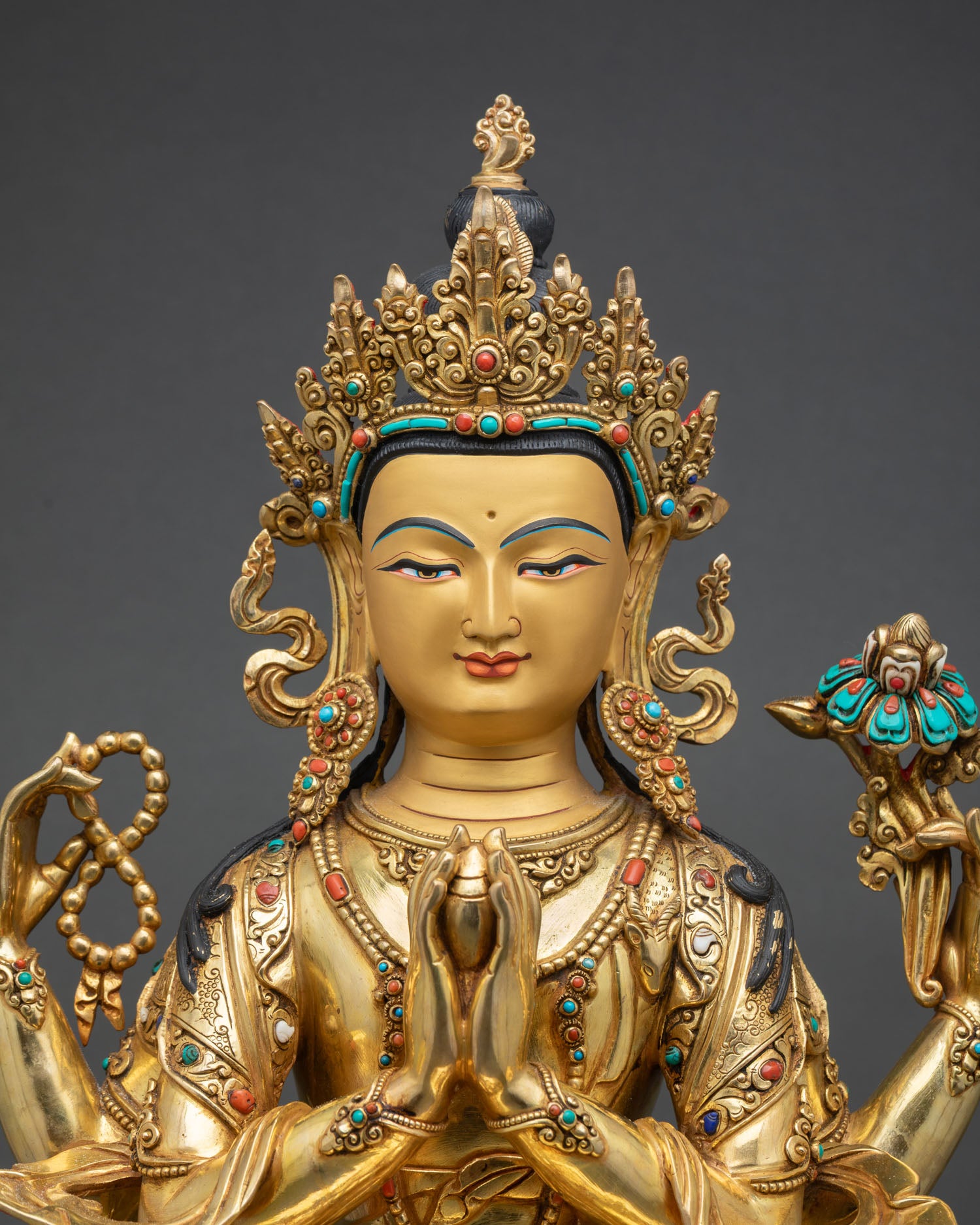 Close up Chenrezig face gold painted finish semi precious stones crystal mala jeweled lotus flower Himalayan Buddhist sacred sculpture