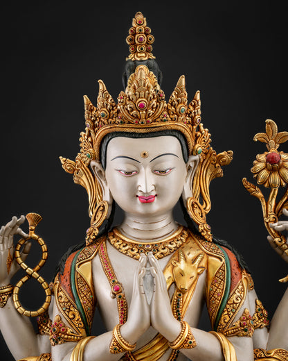 Close up Chenrezig serene face with gold gilded crown flowing robes and intricate hand painted Buddhist craftsmanship details