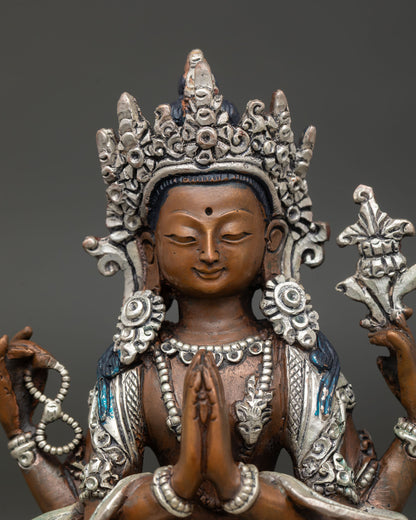 Close up Chenrezig statue, four armed Avalokiteshvara, crystal mala, lotus flower, anjali mudra, serene expression Himalayan Buddhist art