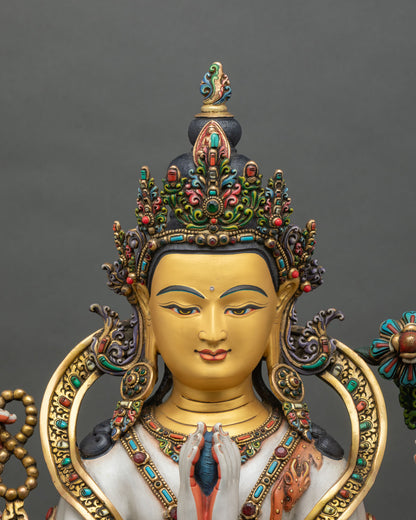 Close-up of Chenrezig statue showing hand-painted robes and gold-gilded ornaments