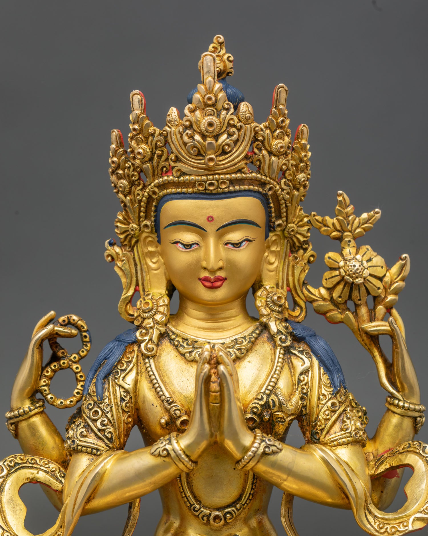 Close up Chenrezig statue serene face gold painted copper