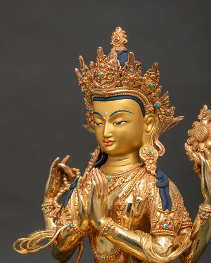 Close up Chenrezig statue showing serene face ornate jewel crown and gold gilded details.