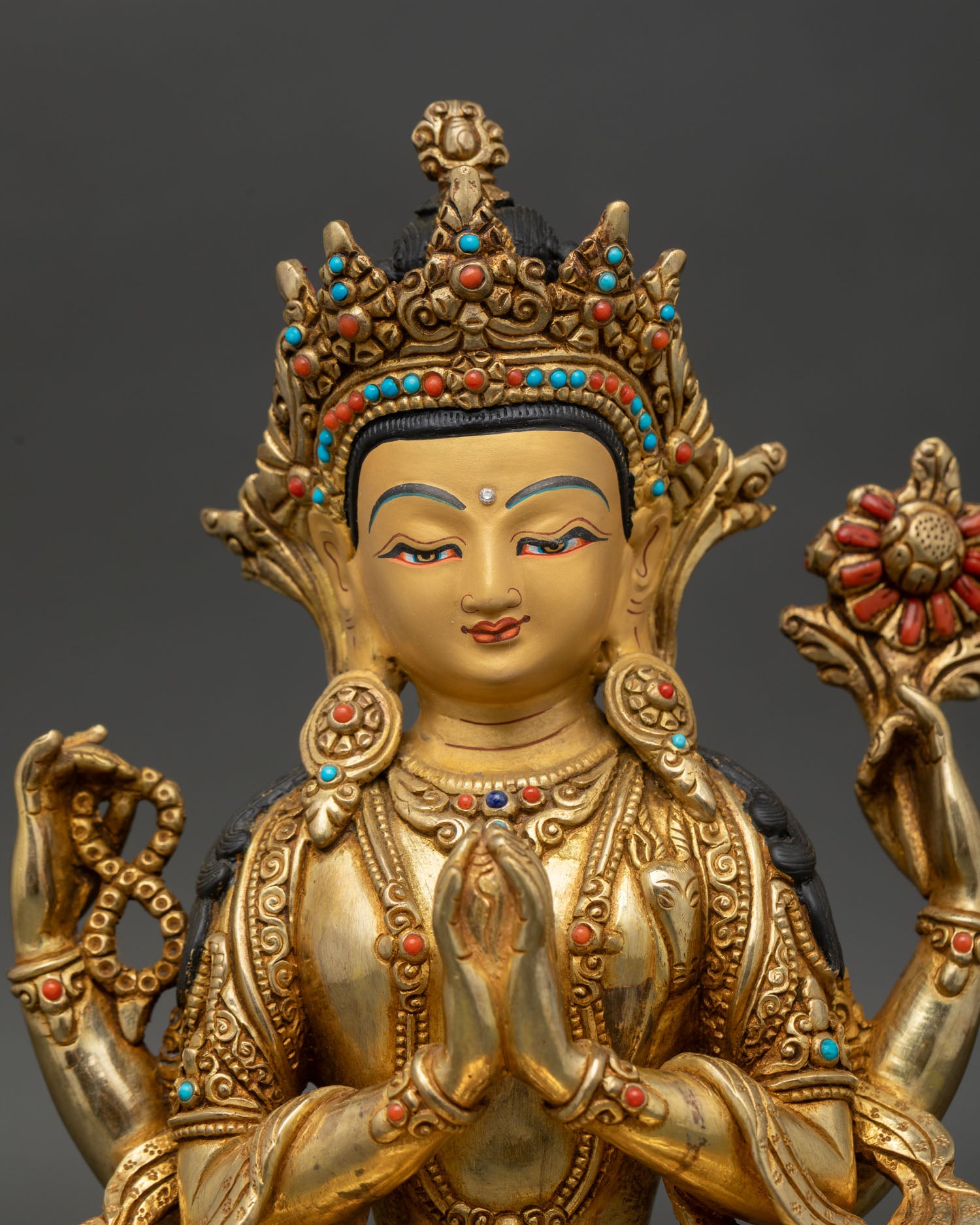 Close up Chenrezig statue wish fulfilling jewel crystal mala lotus flower intricate details