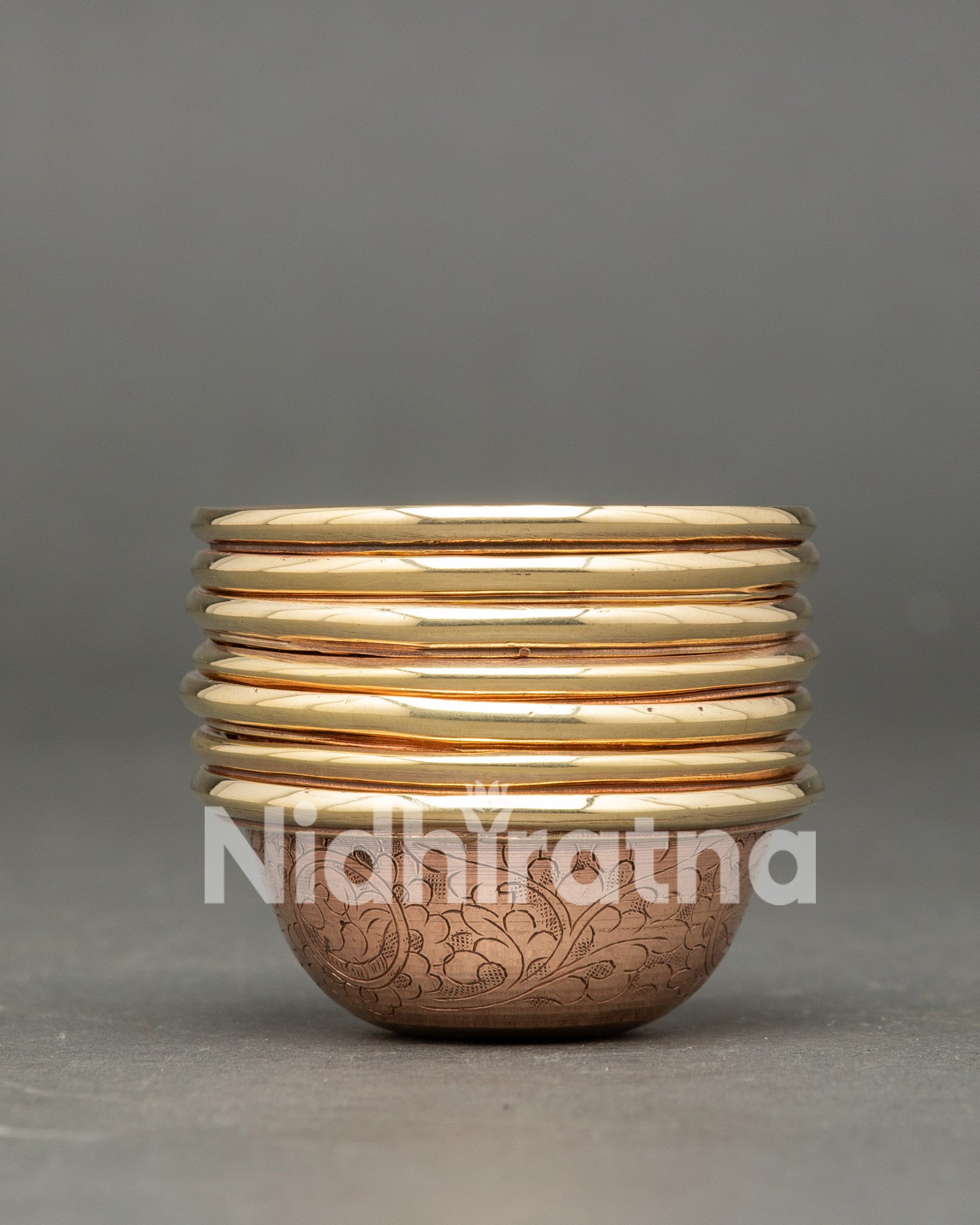 Close up copper bowl engraved with floral motifs for Tibetan Buddhist altar and meditation