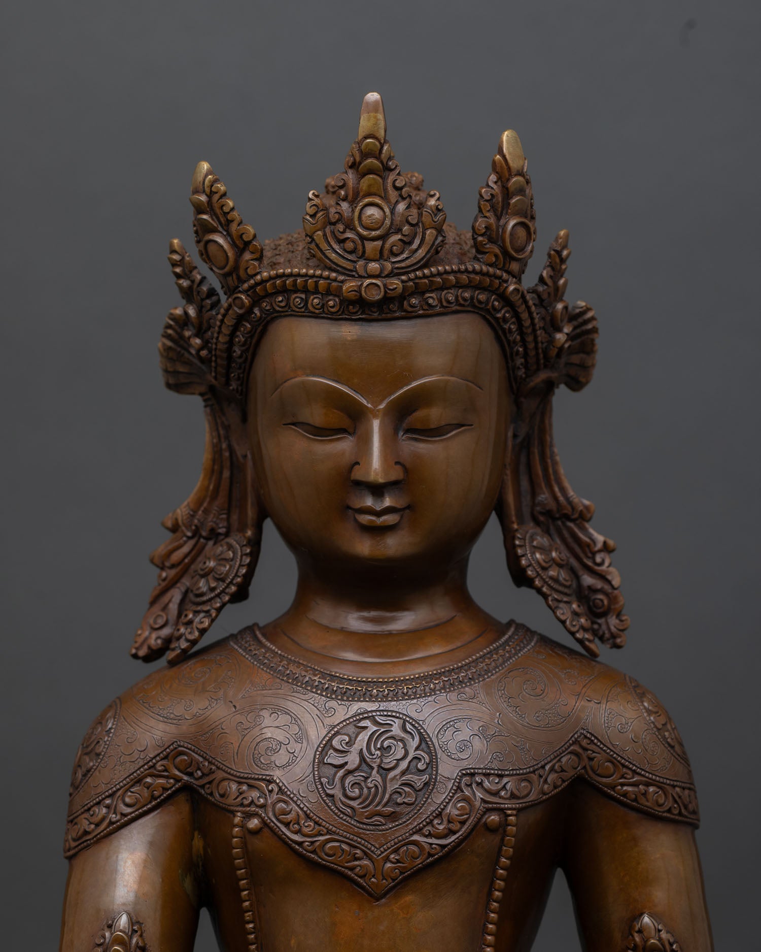 Close up Crown Shakyamuni Buddha sculpture with five point crown and bhumisparsha mudra