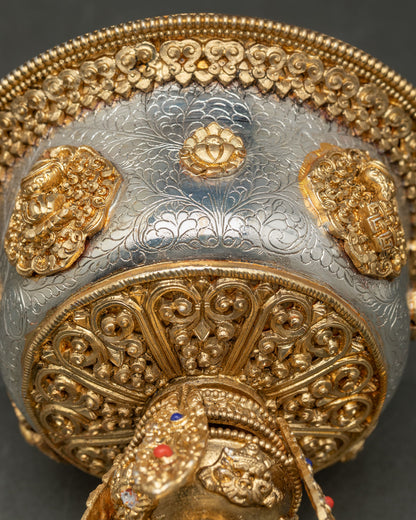 Close up detail butter lamp showing intricate floral motifs delicate filigree carving and sacred Buddhist symbols with gold and silver plated