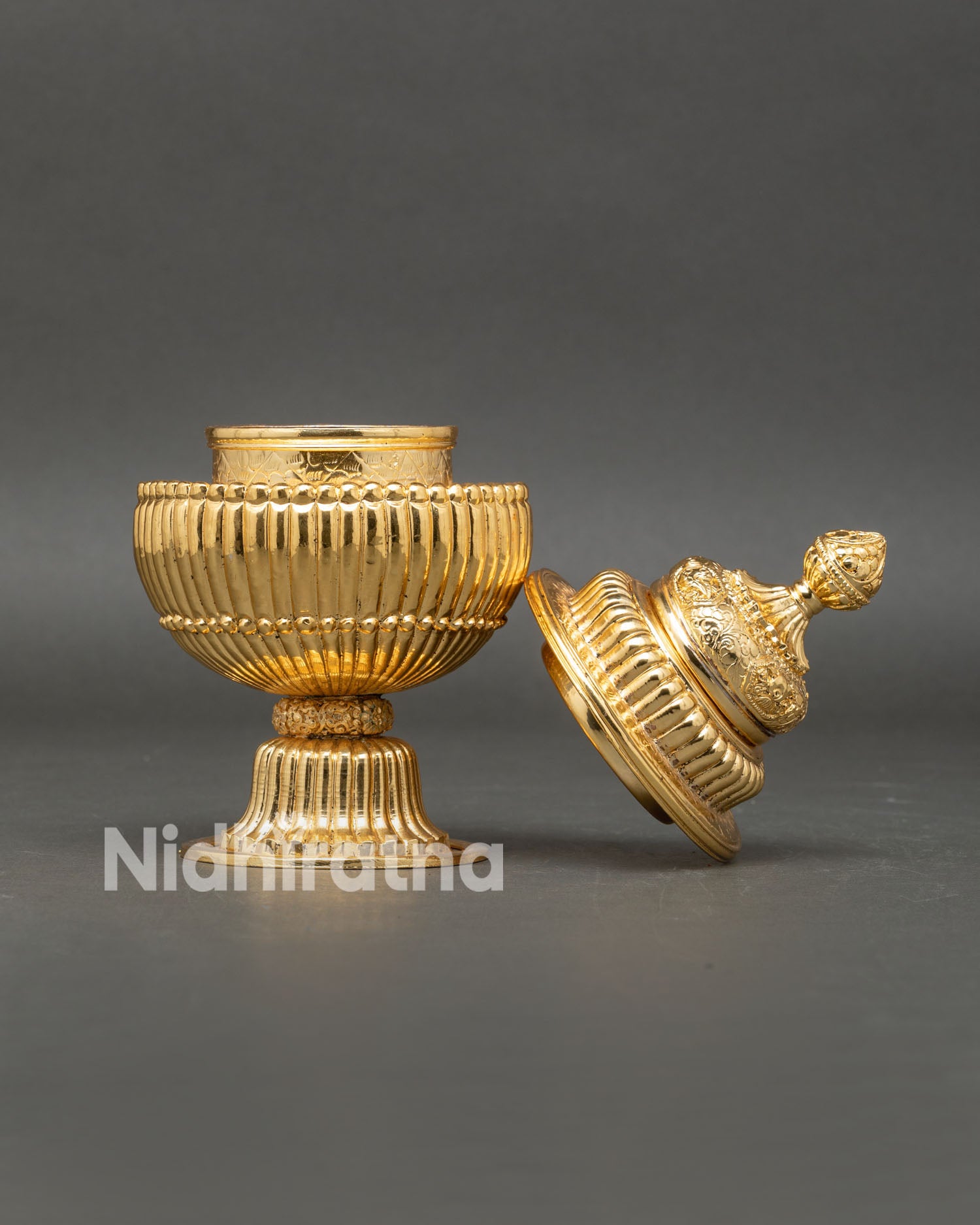 Close up detail Neshi Rice Pot showing intricate ornamental engravings copper craftsmanship and elegant gold plated Himalayan artistry
