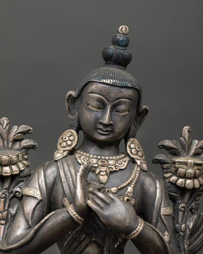 Close up detail of Avalokiteshvara face and dharmachakra mudra showing serene meditative expression silver ornaments and traditional Newari craftsmanship