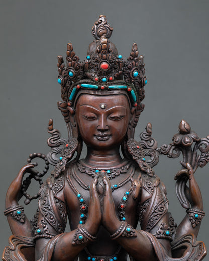 Close up detail of Chenrezig face and four armed form showing closed eyes crystal mala lotus flower and sacred hand gestures crafted by Newari artisans