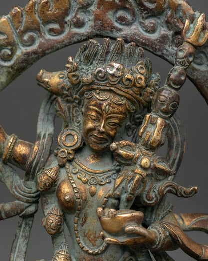 Close up detail of Dorje Phagmo face and jeweled tiara showing fierce enlightened expression antique style gilded copper craftsmanship