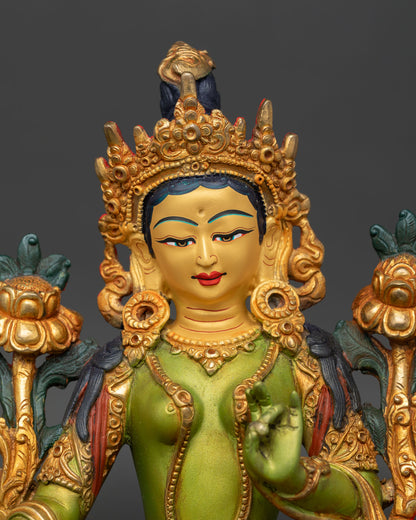 Close up detail of Green Tara face with serene gold painted expression, showcasing fine handcrafted Nepalese Buddhist sculpture artistry.