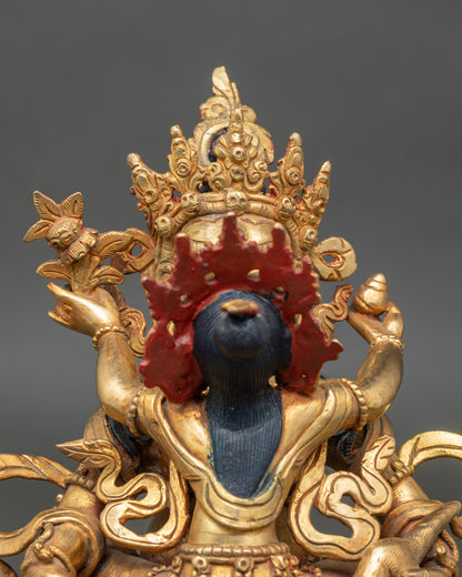 Close up Dzambhala and Consort faces gold painted tantric deity sculpture Nepalese art