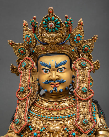 Close up Dzambhala statue gold painted face intricate Newar craftsmanship hand chased detailing repoussé work sacred Buddhist wealth deity