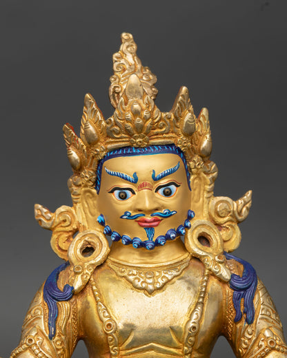 Close up Dzambhala statue jeweled crown detailed ornaments gold gilded face sacred Buddhist craftsmanship