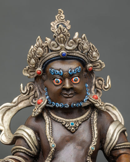 Close up Dzambhala statue ornate crown hand-painted colors and detailed ornaments