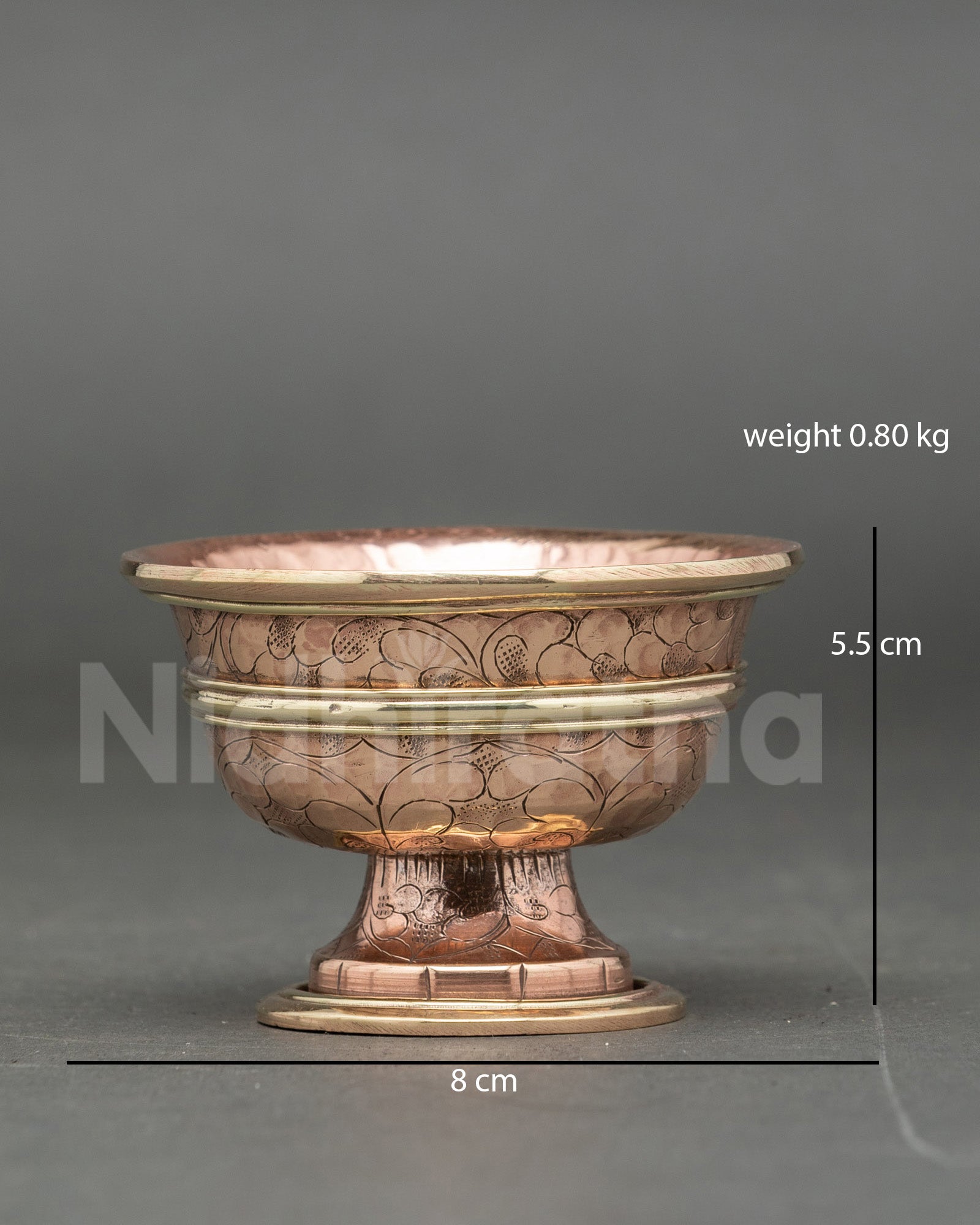 Close up engraved floral seven water offering bowl copper handcrafted Buddhist ritual