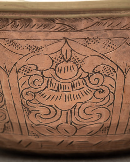 Close up engraved water offering bowl copper featuring auspicious Buddhist symbols