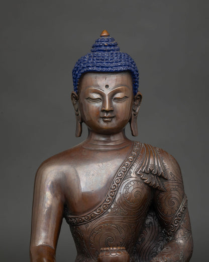 Close up of the Buddha's face showing the chemically oxidized copper patina.