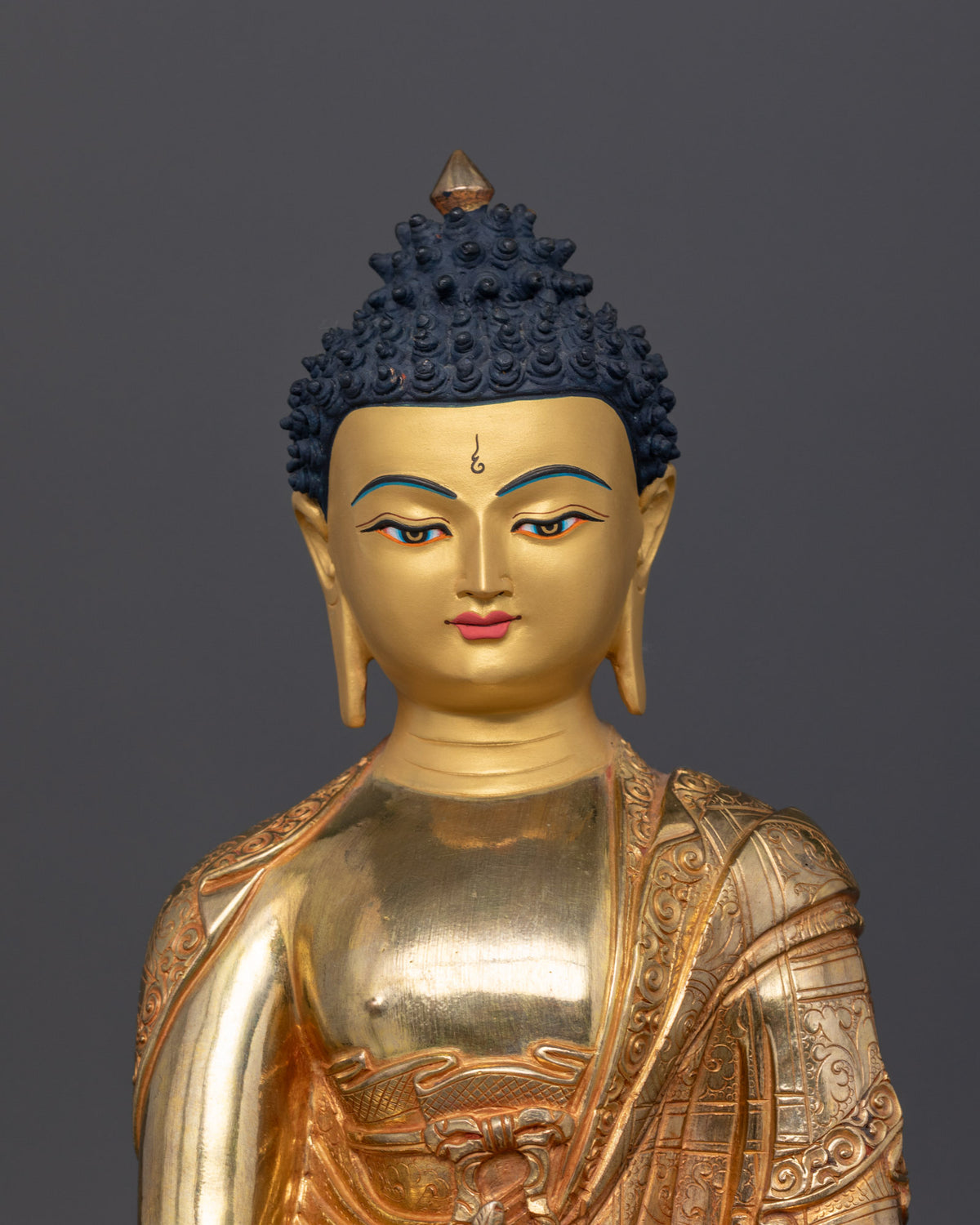 Close-up front view of Medicine Buddha featuring a finely painted gold face and a serene expression, showcasing traditional Nepalese craftsmanship.