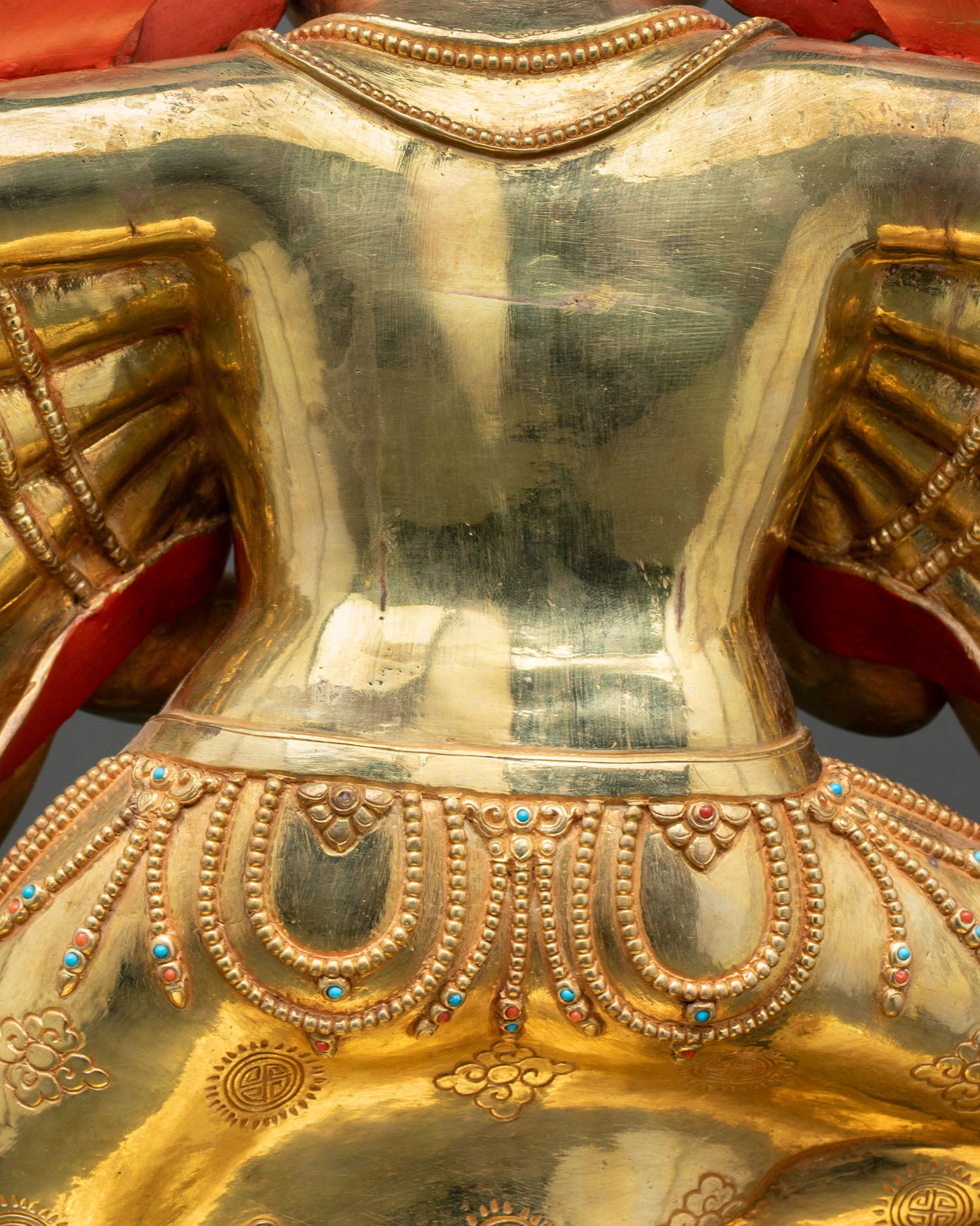 Close-up gold back and shoulder detail of handcrafted Ganesh statue