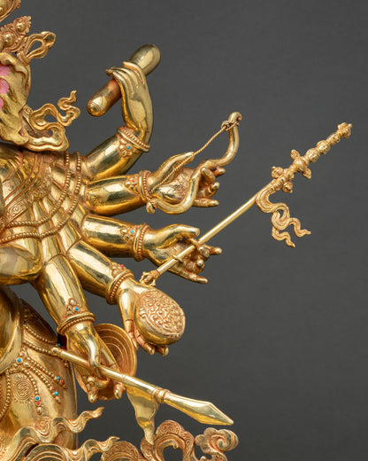 Close-up gold hand of Ganesh statue holding sacred staff weapon