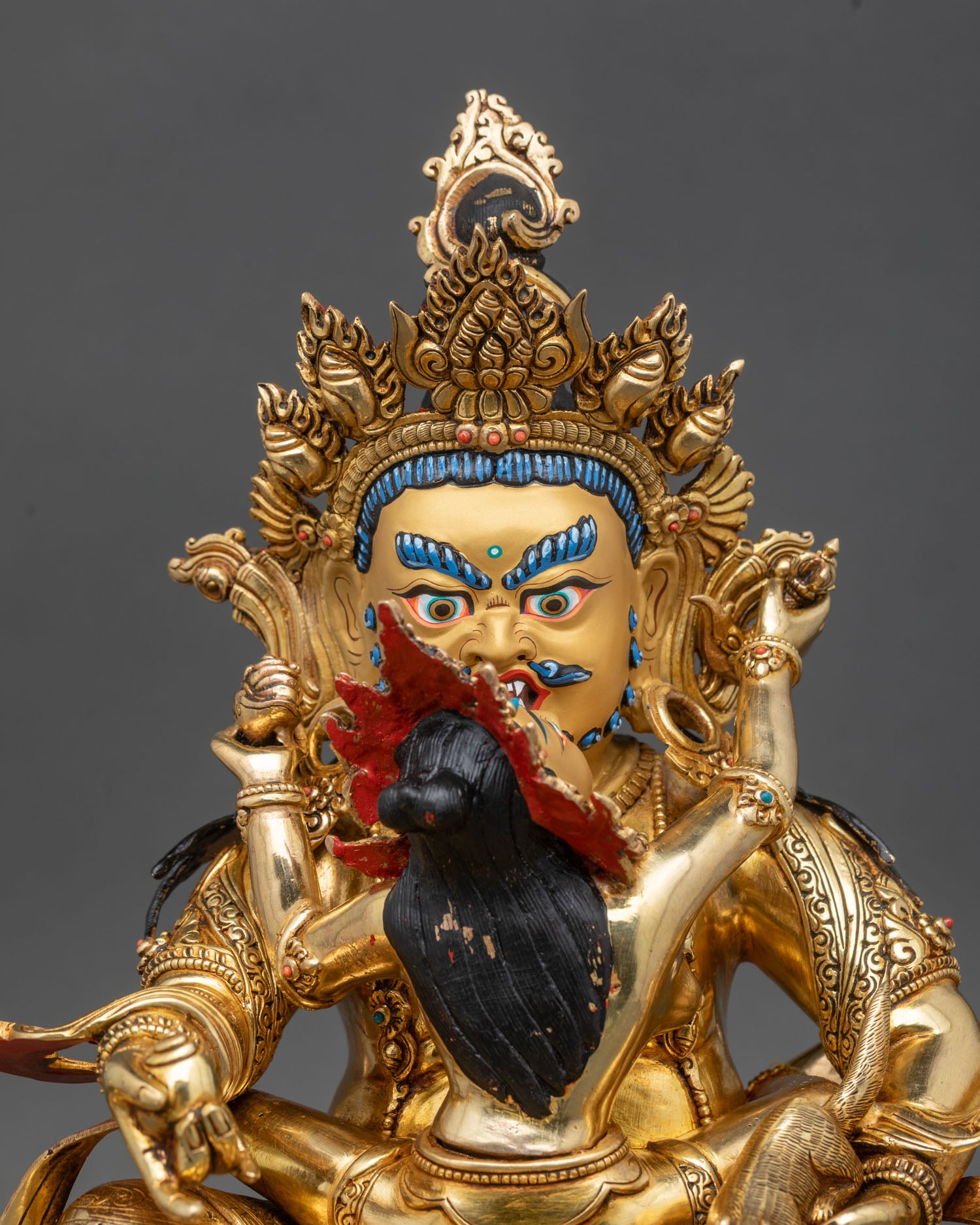 Close up of Green Dzambhala face with gold painted beard, handmade by Newari artisans from Patan, Nepal.