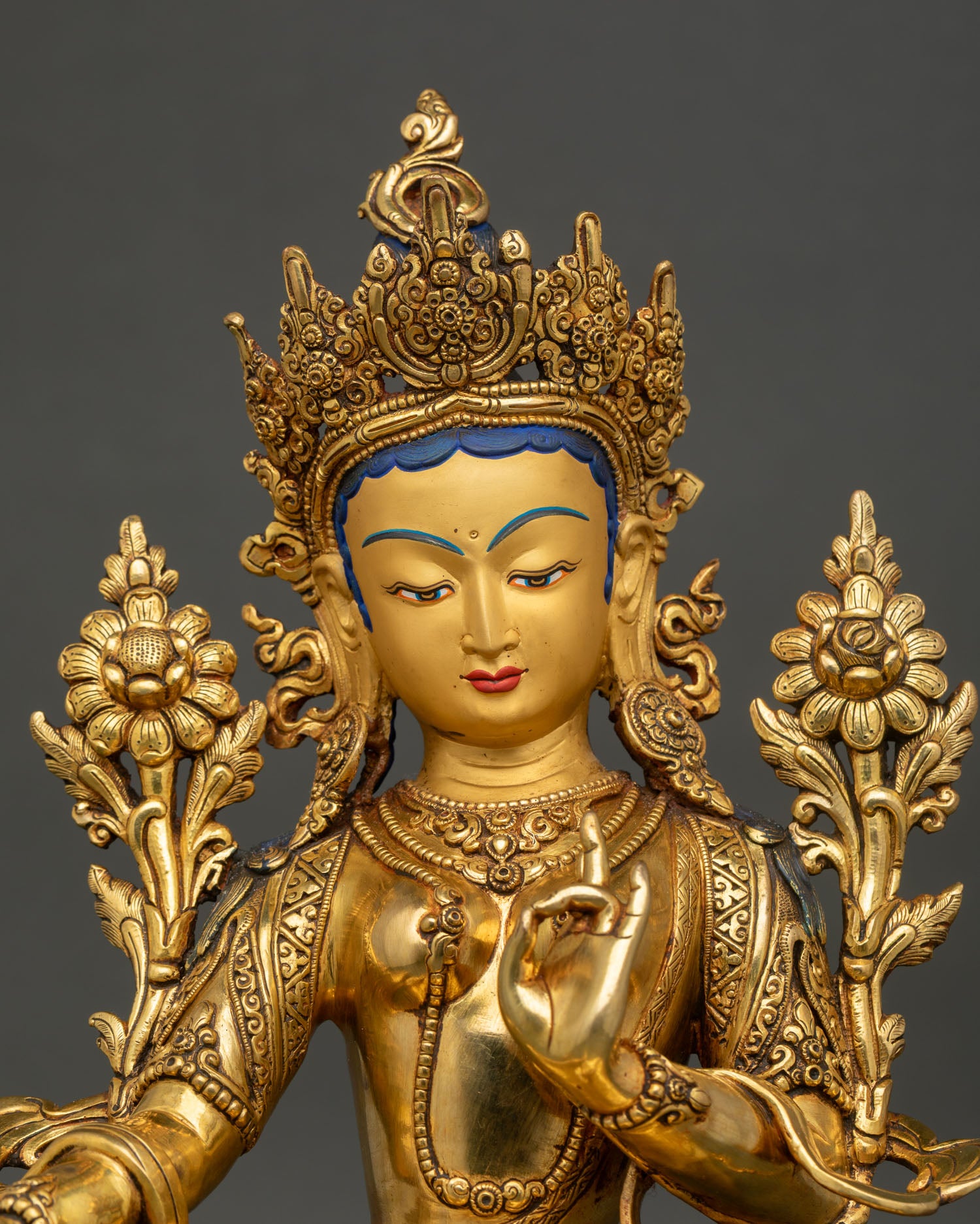 close up green tara droljang statue showing intricate gold gilded details