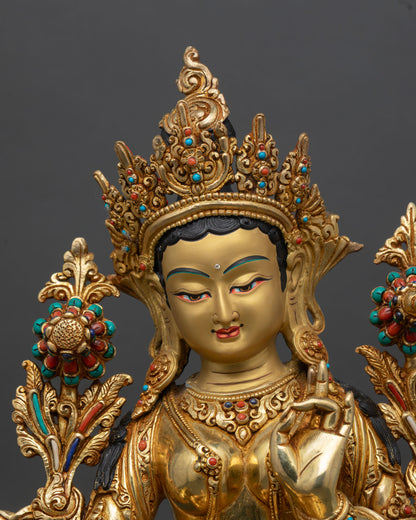 Close up green tara face gold painted expression semi precious stones himalayan buddhist sculpture detail