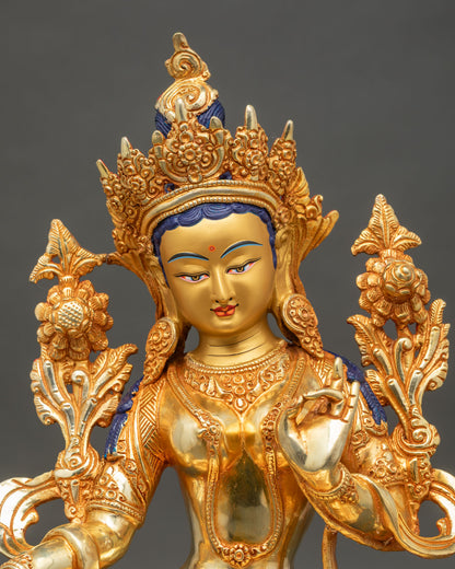 Close up Green Tara face serene expression gold painted detailed craftsmanship