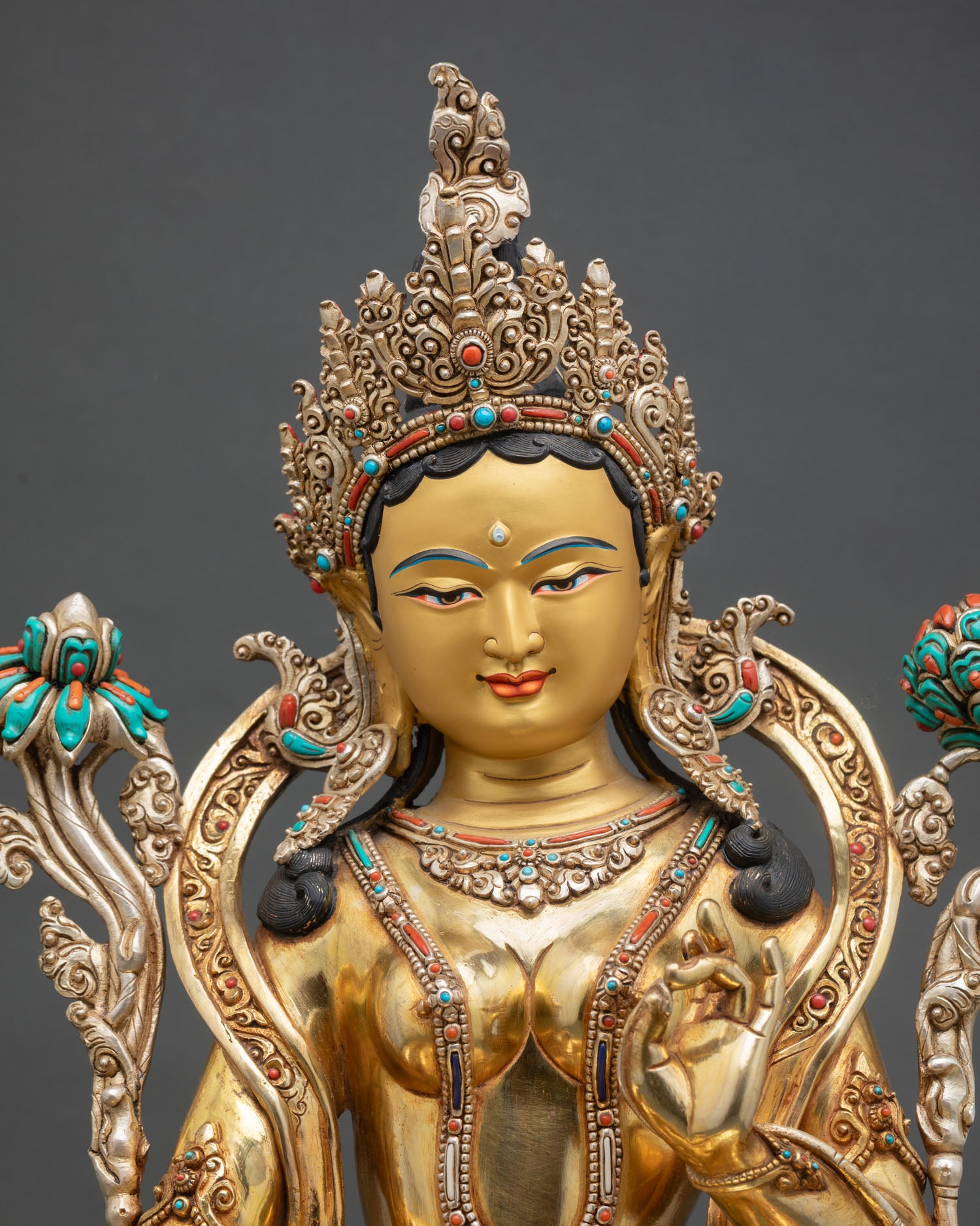 Close up Green Tara face with gold painted expression serene compassion and finely crafted Newari artistry