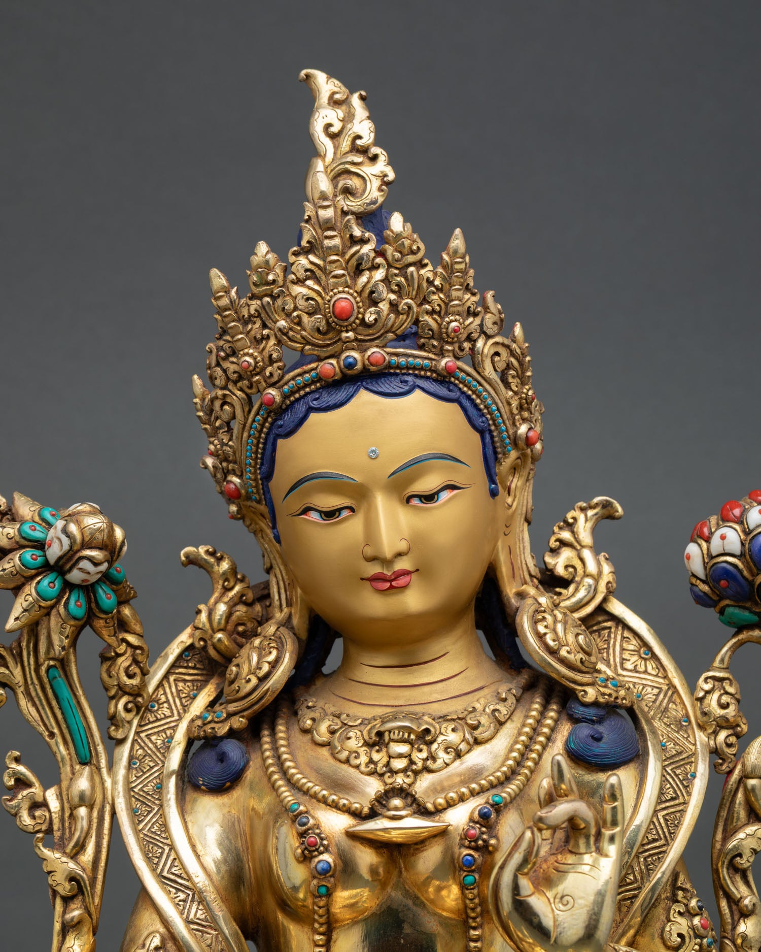 Close up Green Tara face with gold painted expression serene compassion and Himalayan Newari artisan detailing