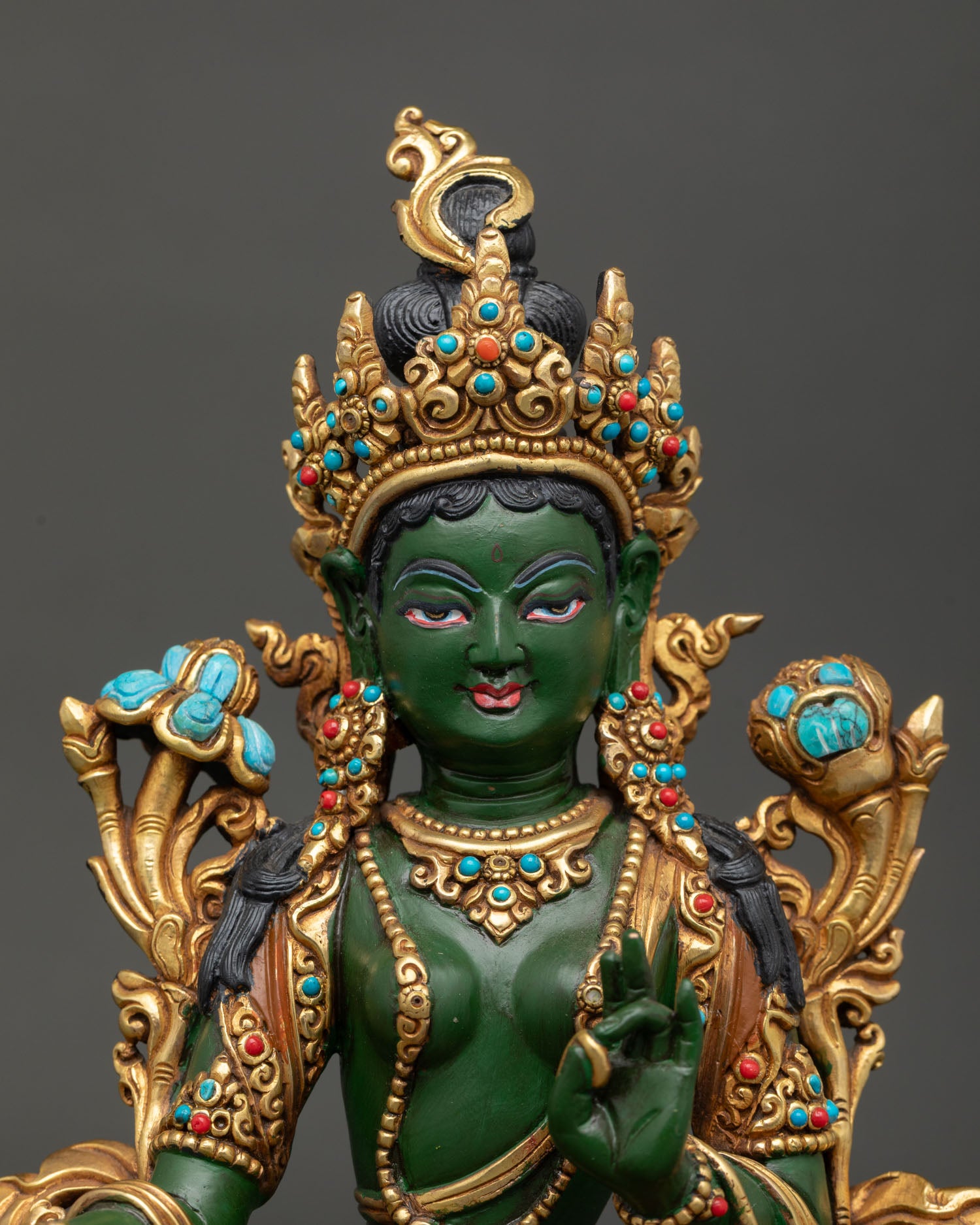 Close-up Green Tara face with vibrant colors, gold details, and sacred expression
