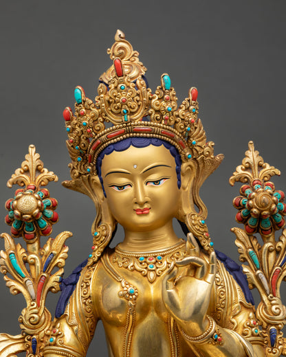 Close up Green Tara goddess statue gold painted serene face detailed expression Himalayan craftsmanship sacred Buddhist art