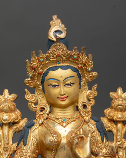 Close up Green Tara goddess statue serene expression hand painted face utpala lotus detail Himalayan craftsmanship