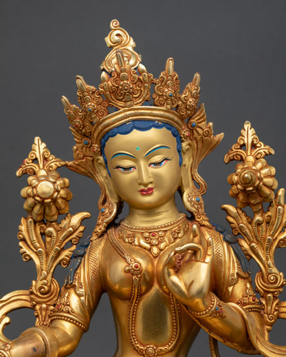 Close up Green Tara gold painted serene face detail semi precious stones copper statue with 24K gold fire gilding Himalayan Nepalese Buddhist craftsmanship