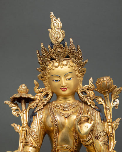 Close up Green Tara, serene expression with crown jewelry, varada mudra and lotus stem detail