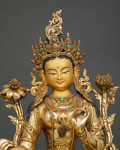 Close up Green Tara serene gold painted face with intricate crown turquoise and coral stone ornaments Himalayan craftsmanship detail
