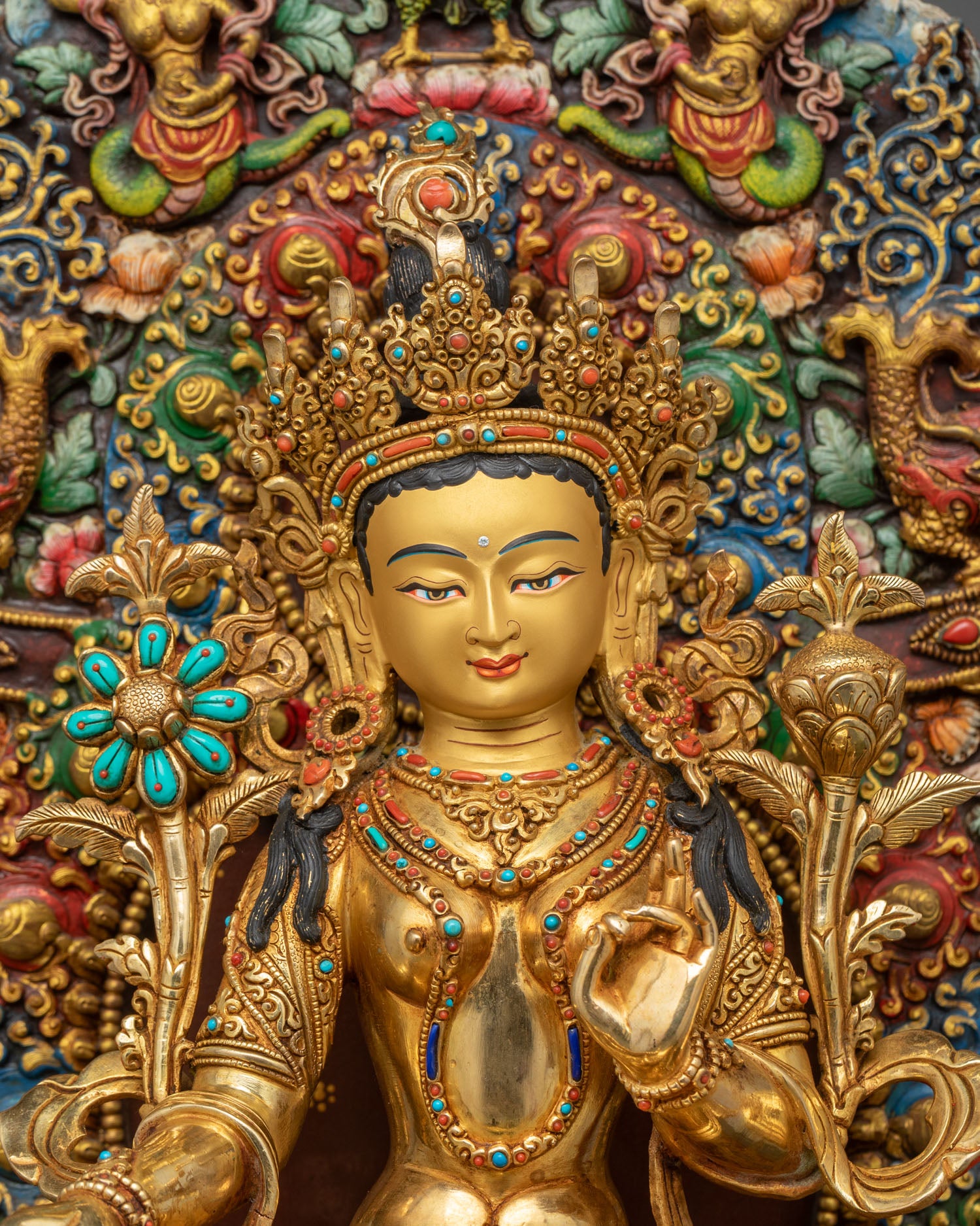 Close up Green Tara statue showing five-jeweled crown and detailed facial features