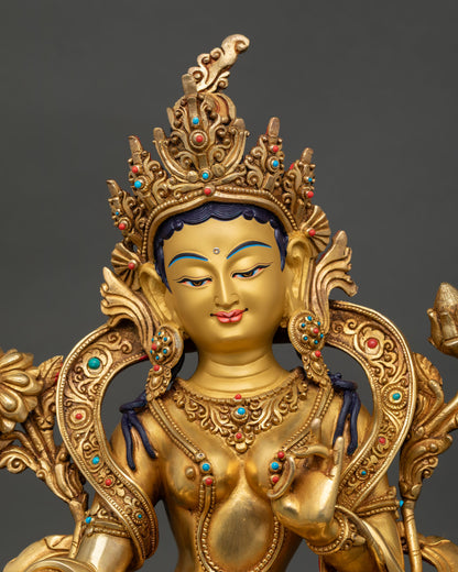 Close up green tara statue hand painted golden face with semi precious stones detailed facial expression buddhist goddess of compassion