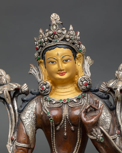 Close up Green Tara statue serene expression five jeweled crown semi precious stones, Himalayan Newari artisan sacred sculpture 