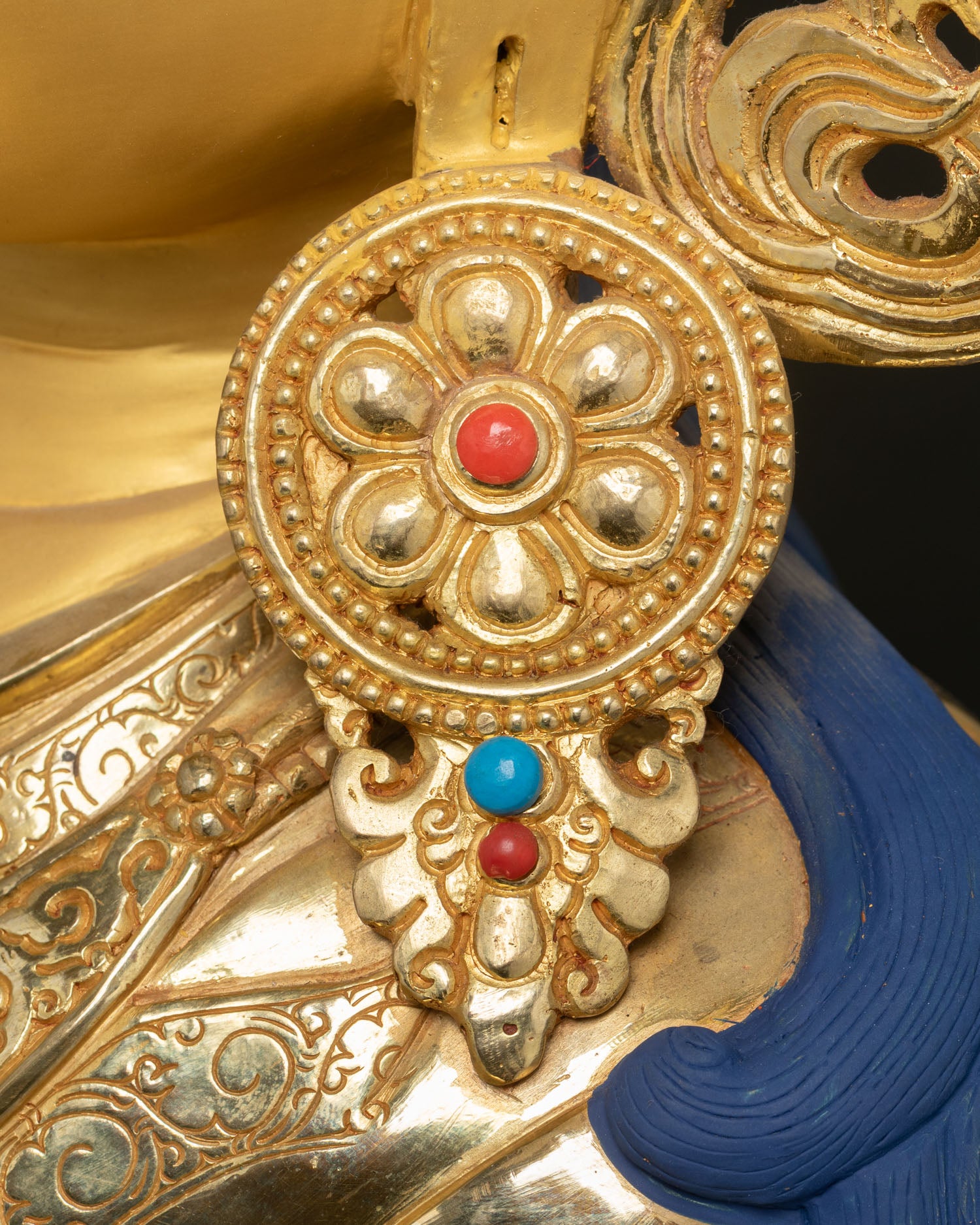 Close up Guru Rinpoche earrings and jewelry showing intricate Newari artisan metalwork details