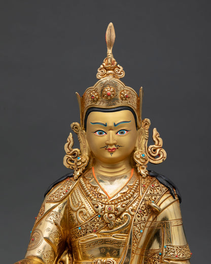 Close up view of Guru Rinpoche face showing gold painted details with scroll and floral motifs and Himalayan craftsmanship