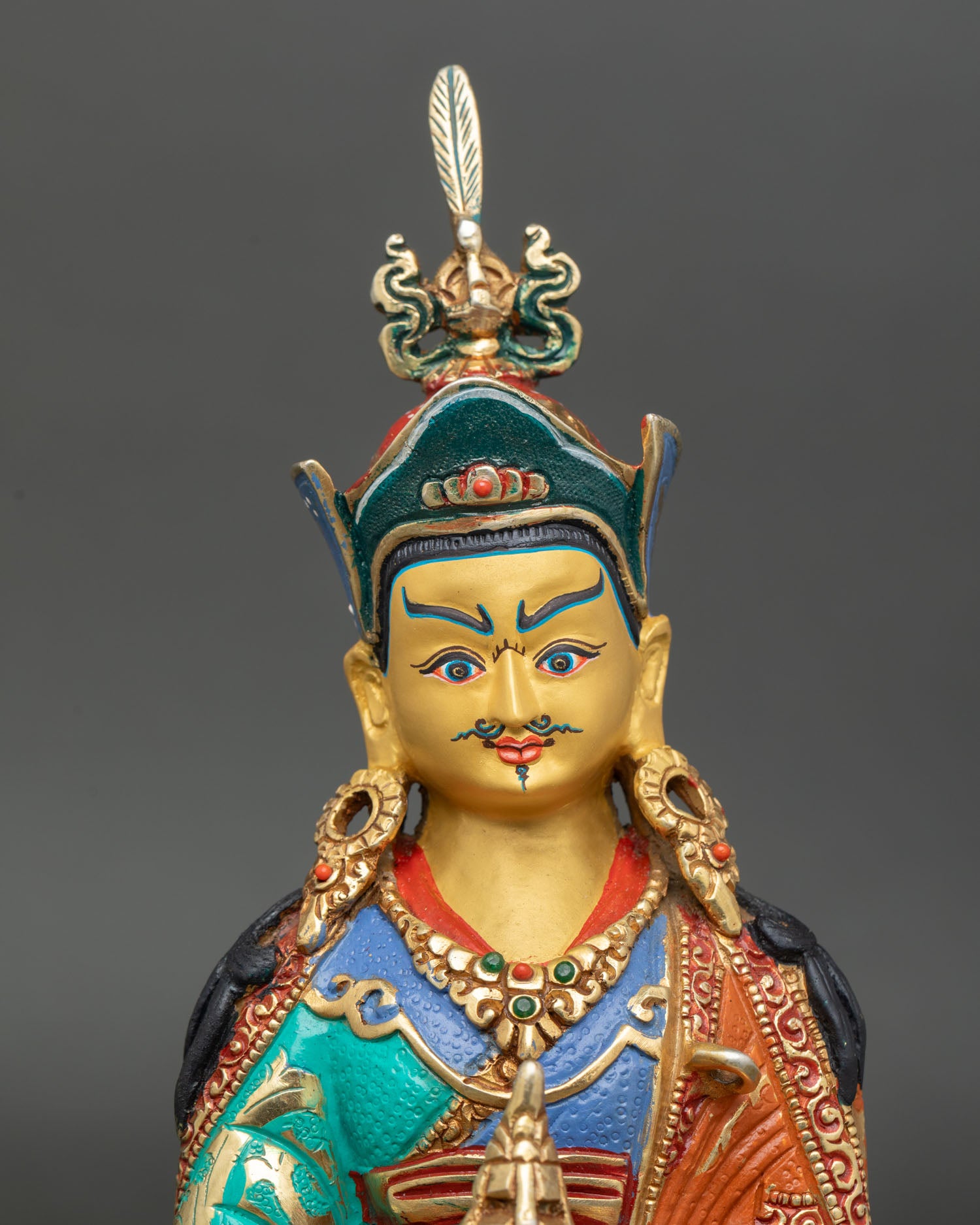 Close up Guru Rinpoche face, gold painted serene expression, Himalayan Buddhist master statue, artisan craftsmanship 
