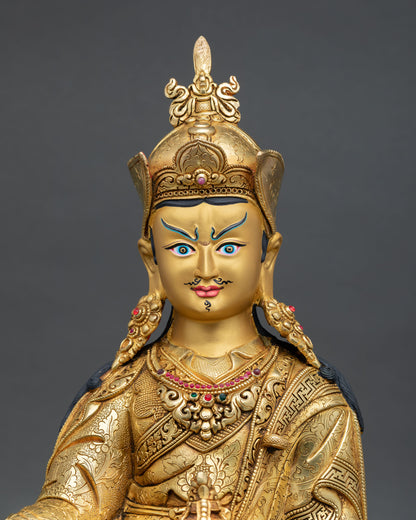 Close up Guru Rinpoche face with gold painted expression serene wisdom and Himalayan Newari artisan detailing