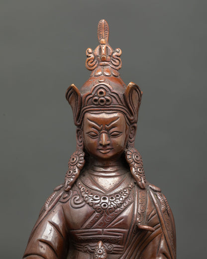 Close up Guru Rinpoche face with lotus hat vulture feather and semi wrathful expression.