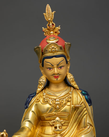 Close up Guru Rinpoche gold painted face serene expression vajra details Tibetan Buddhist sculpture spiritual wisdom and protection icon