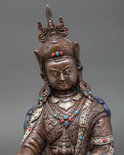 Close up Guru Rinpoche Padmasambhava statue showing detailed facial expression oxidized copper finish sacred Himalayan Buddhist art
