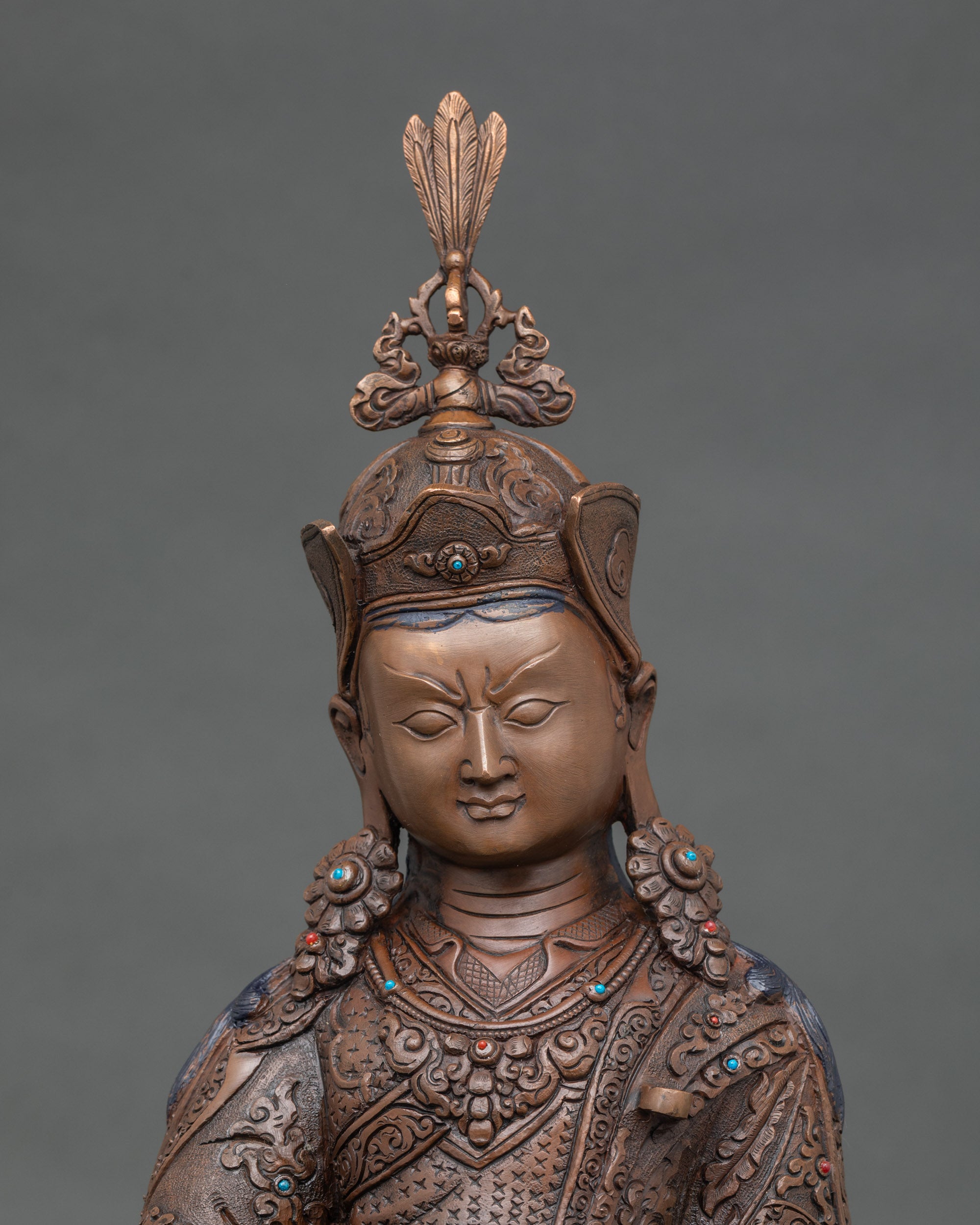 Close up Guru Rinpoche sacred figure hand-carved robes spiritual guidance blessings meditation decor