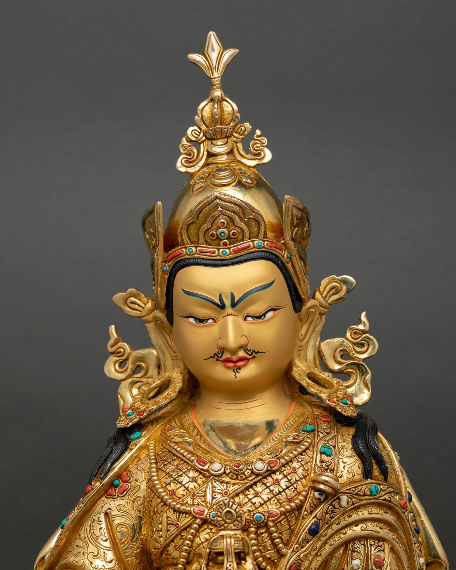 close up guru rinpoche statue copper gold gilded intricate details nepal